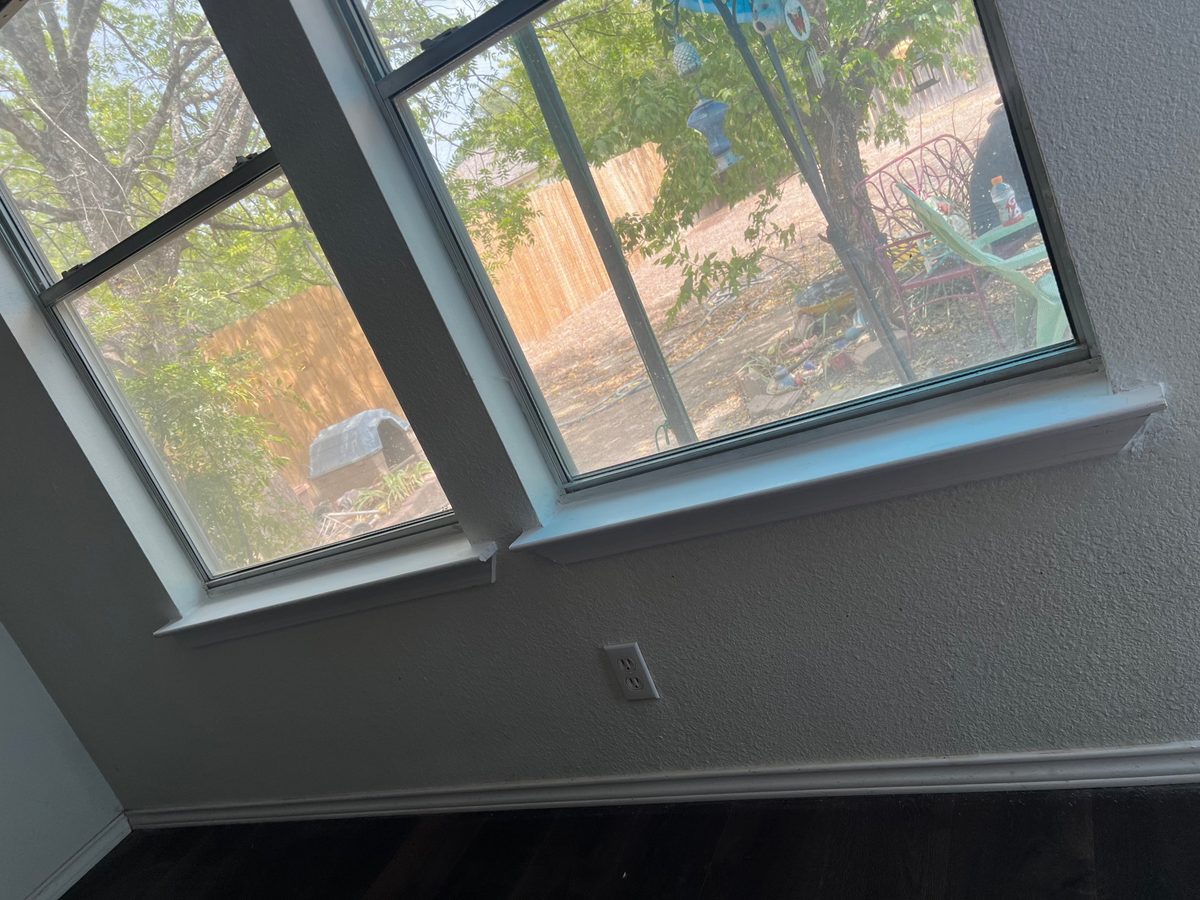 The same windows with a new sill and apron, painted white
